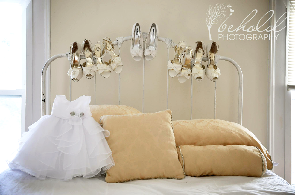 little girls dress and shoes on iron bed.PNG