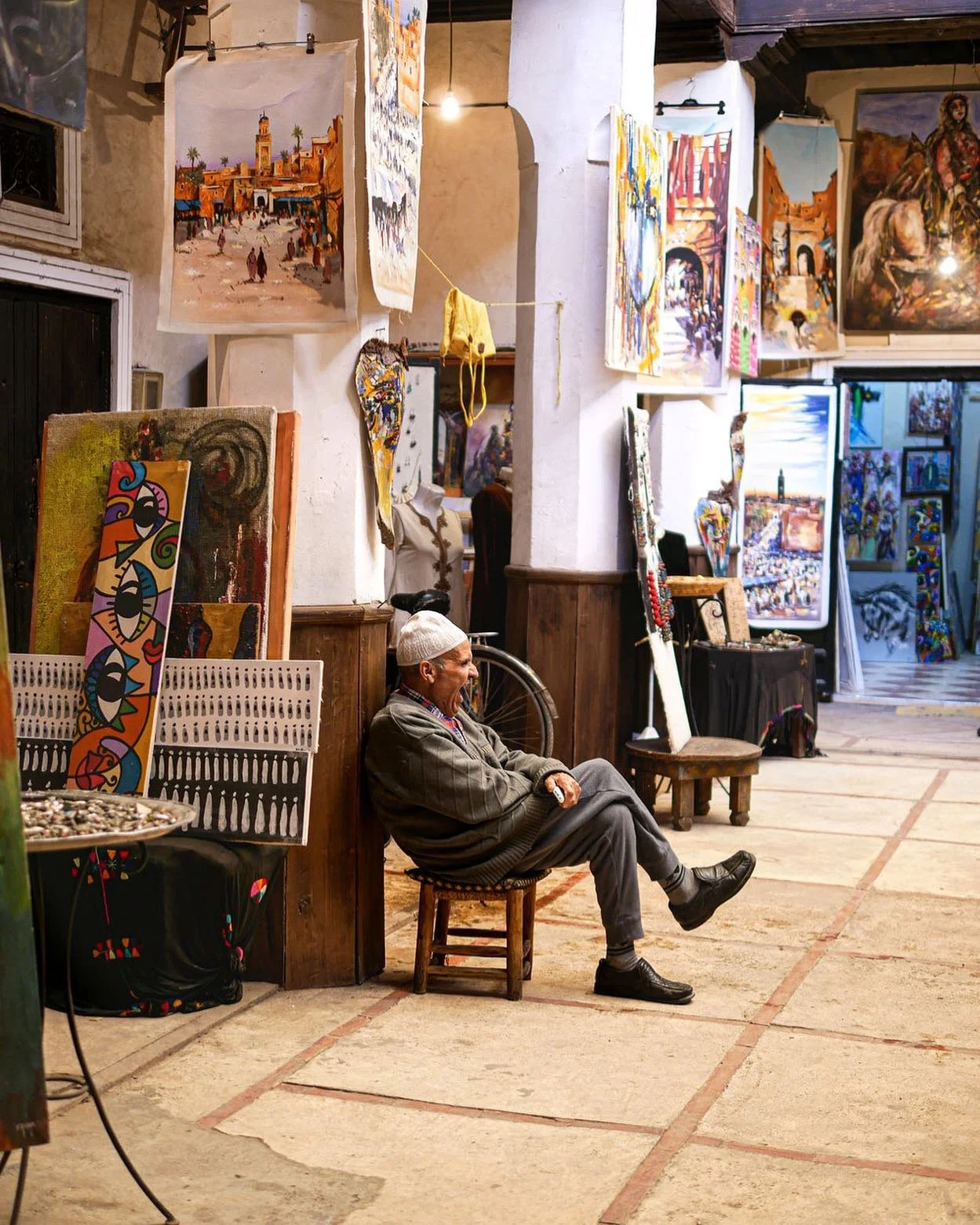 An art seller yawns, Marrakech medina