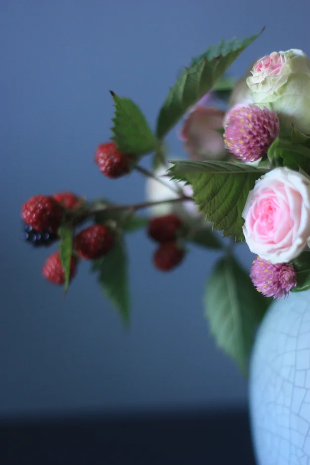 bouquet of mini roses, globe amaranth and black berries