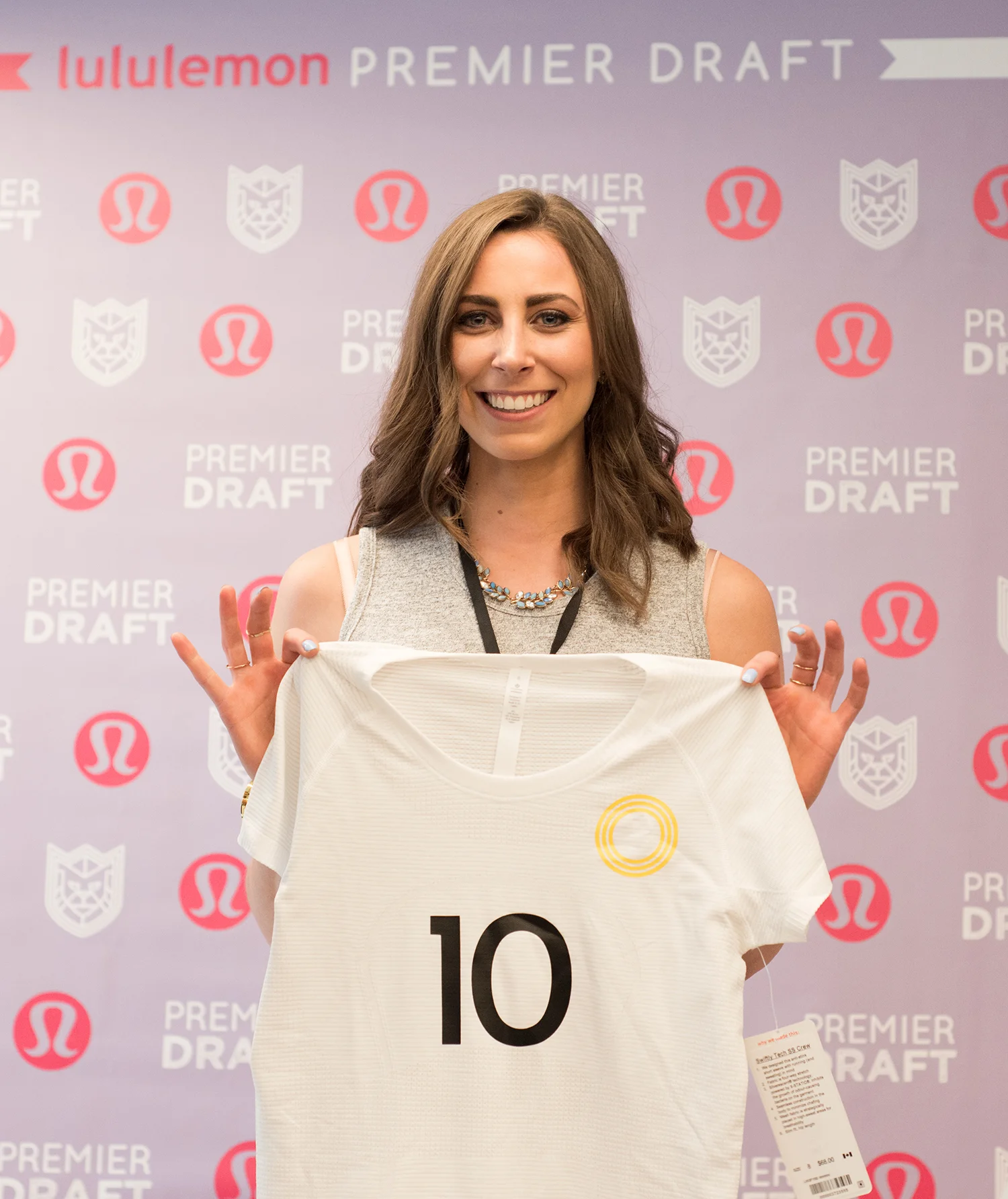 Former Team Canada athlete Tesca A-W holds up her new Premier League jersey at the lululemon Athlete Draft