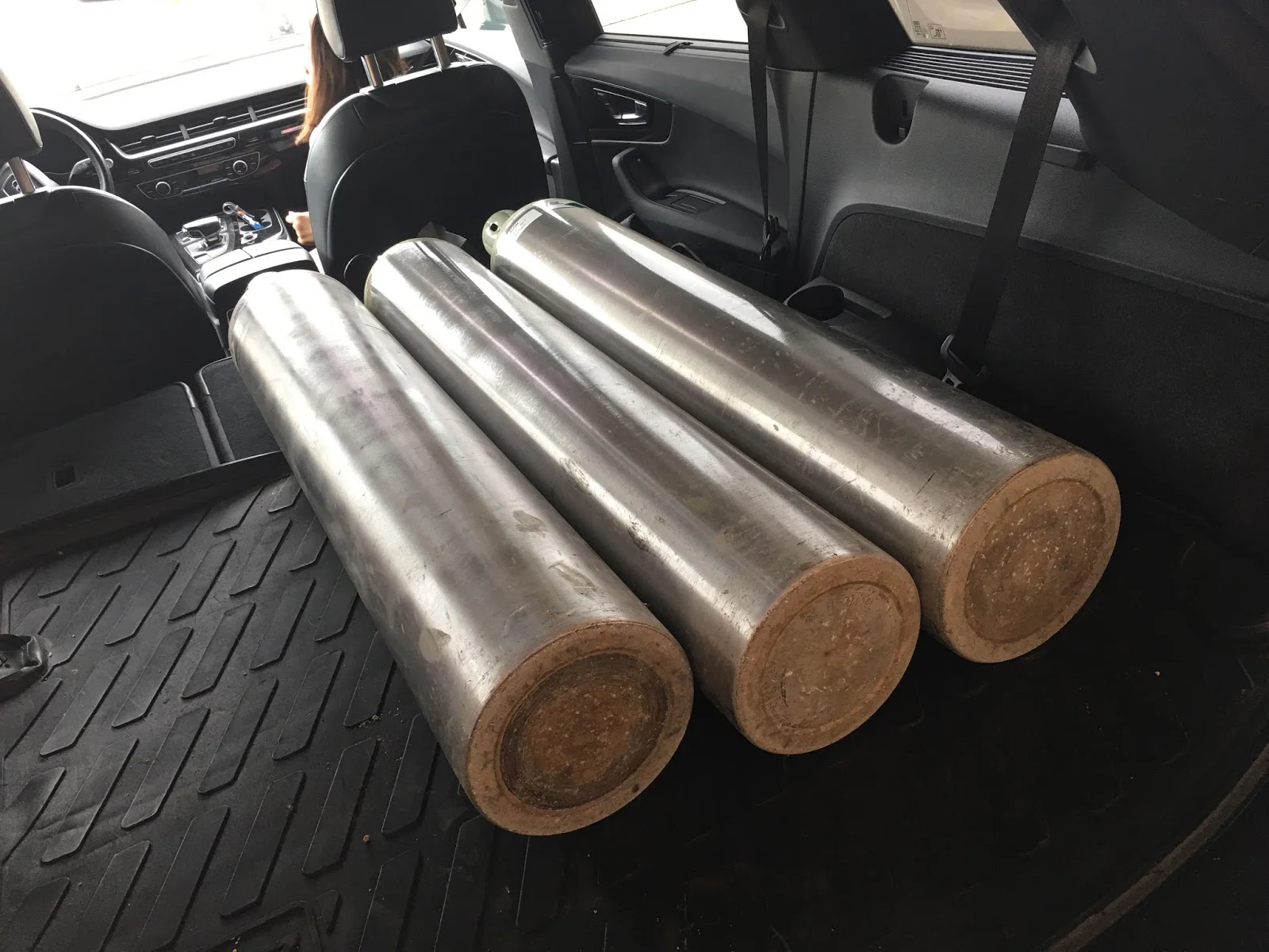 Three of the four 139 cubit foot tanks provided by my local gas supplier, loaded into my SUV so you can gauge the size. Not tiny, but they're aluminum and light.