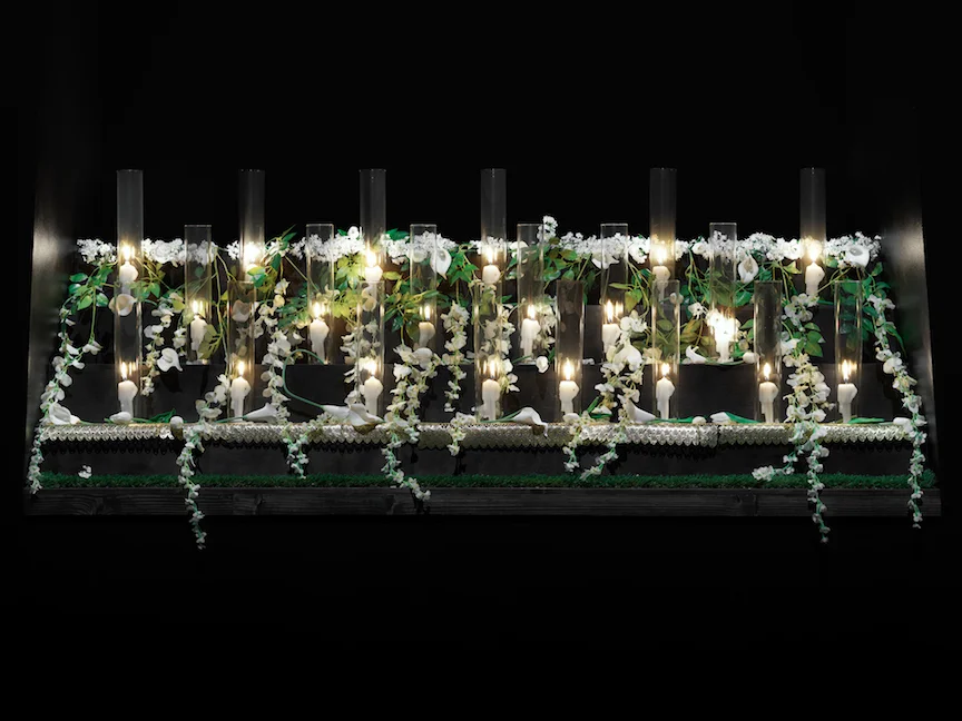 Kenya (Robinson) Alter, 2017 Hand cast wax candles, silk flowers, plastic beads, plastic tables cloths, doilies Dimensions variable, Courtesy Pioneer Works