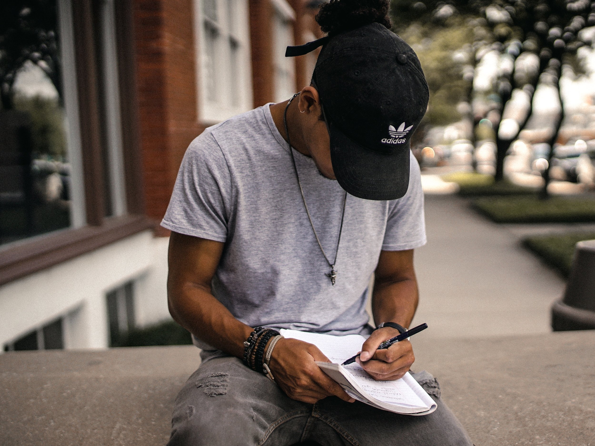 Man sitting writing in his journal