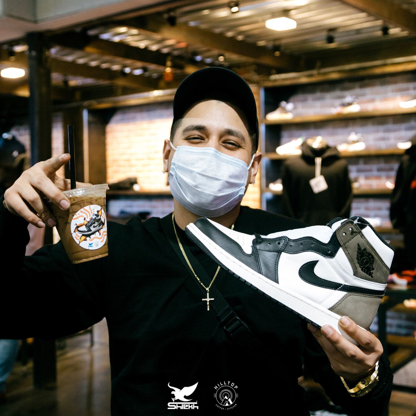 Man holding coffee and sneakers