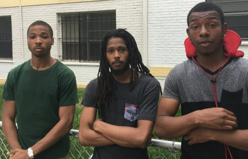Ahrown Jones, his older brother Christopher Jones, and Marcus Robinson (left to right) visit friends and family at Brookland Manor. All three grew up in the complex; Christopher has since served in the Navy and started a local non-profit agency. All three had stories about seemingly arbitrary rules and aggressive conduct by the complex’s former security employees. Image by the author, Pete Rodrigue.