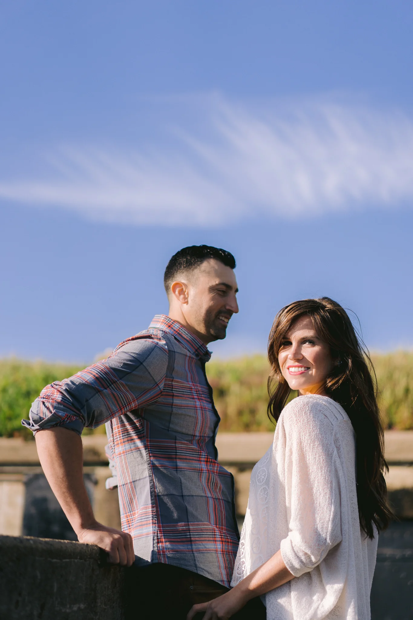 Stephanie & Danny posing romantically during their engagement session near Baker Beach and Battery Chamberlin in San Francisco, CA