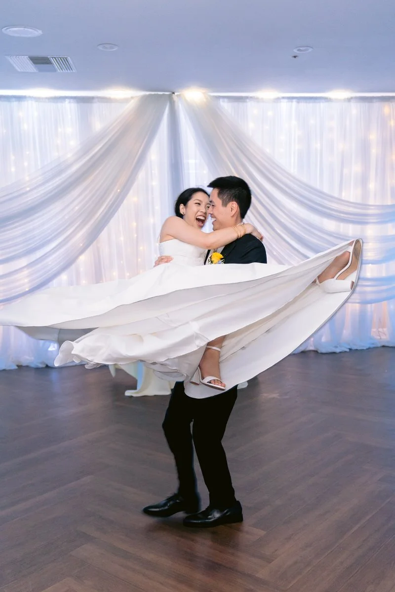 Groom spinning bride during their first dance at their wedding reception at San Ramon Waters