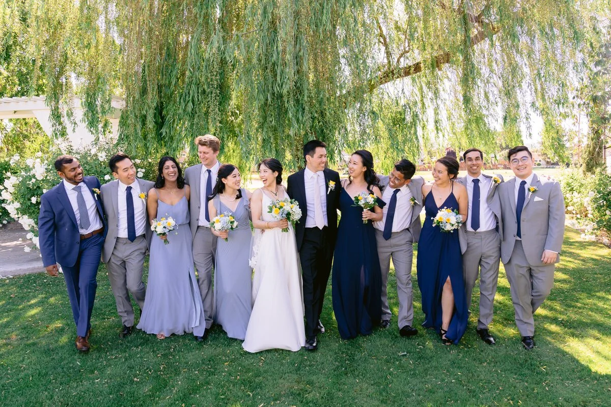 Wedding Party walking with bride and groom in front of weeping willow tree at San Ramon Waters wedding