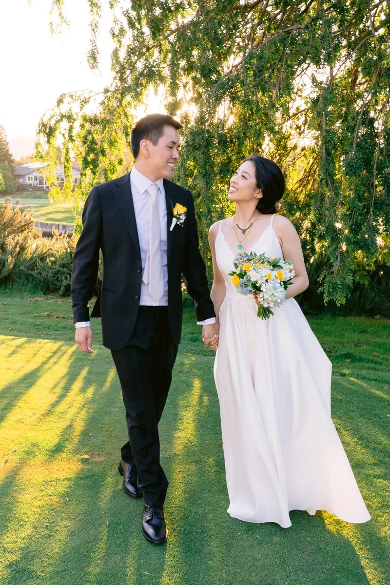 Sunset photo of bride and groom holding hands at their San Ramon Waters wedding