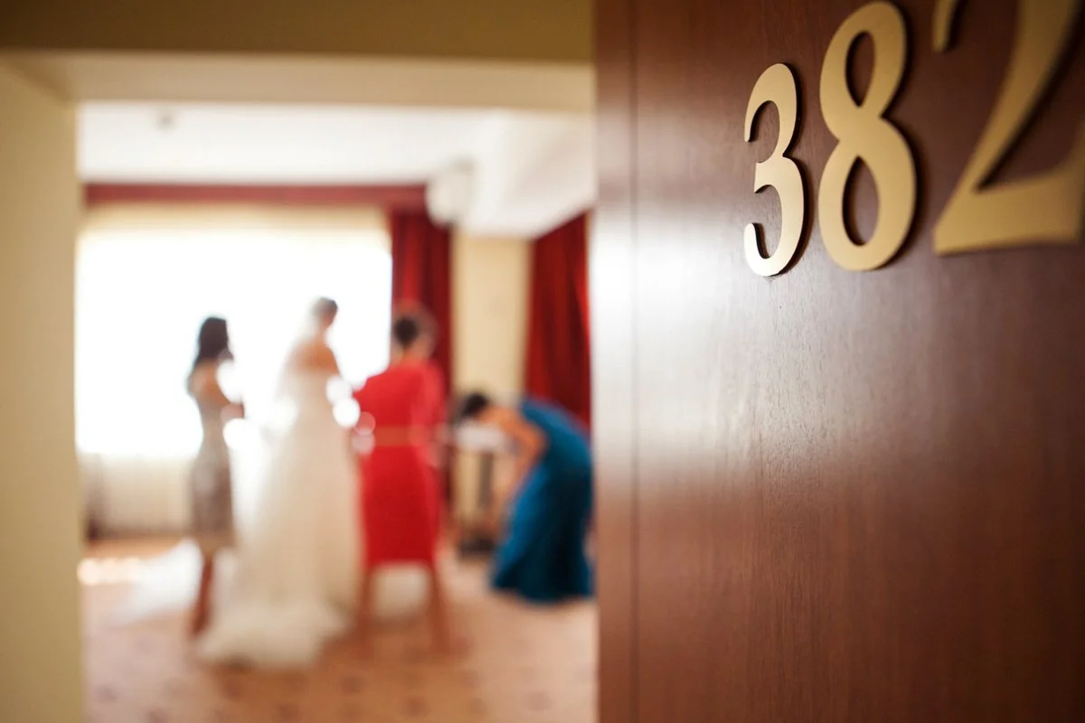 Room 382 with blurred people inside, likely preparing for a wedding event.