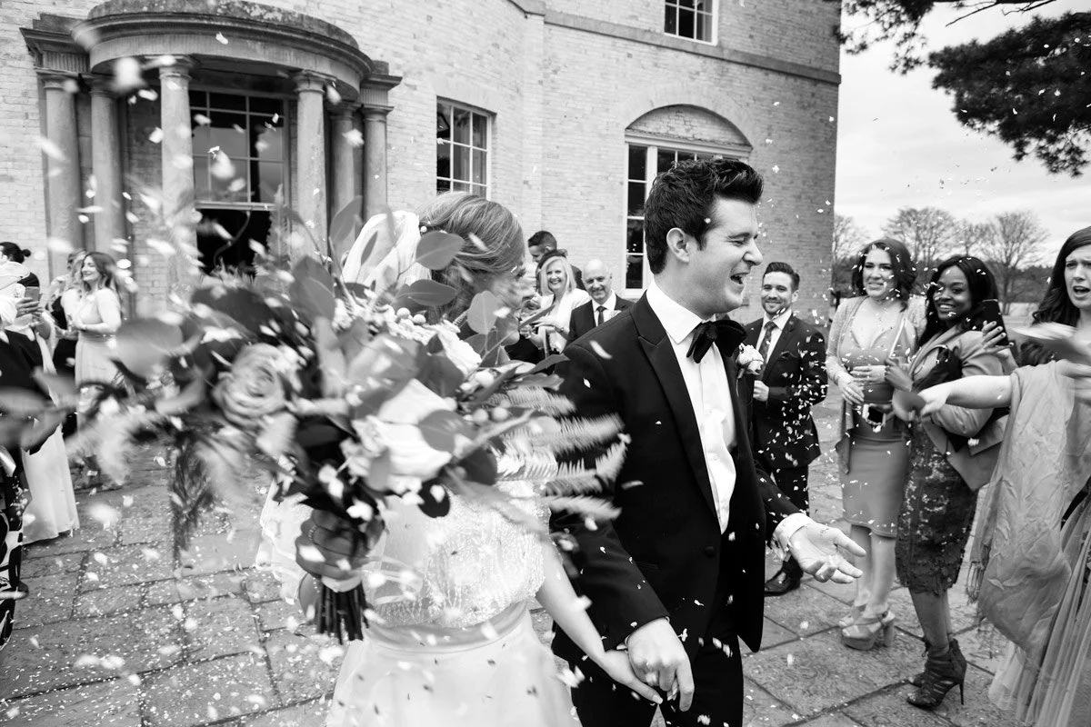 Witness the magic as the newlyweds step into a world of confetti dreams. As a wedding photographer, I capture the bride and groom, surrounded by a vibrant cascade of joy, symbolizing the love and happiness that envelops them on this unforgettable jou