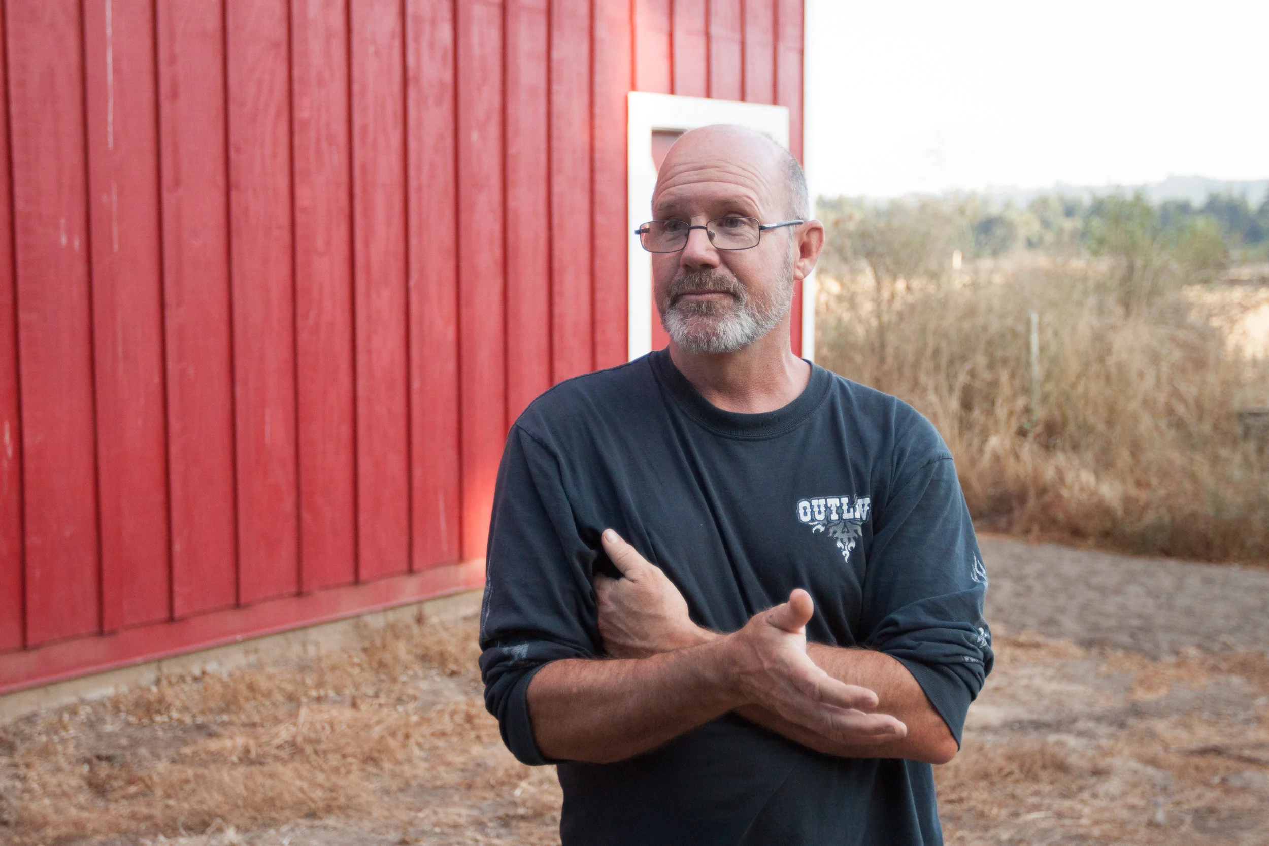 Michael O’Loughlin, owner and operator on the farm standing near his barn built in 1937.