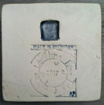 Tile notched on back for hanging