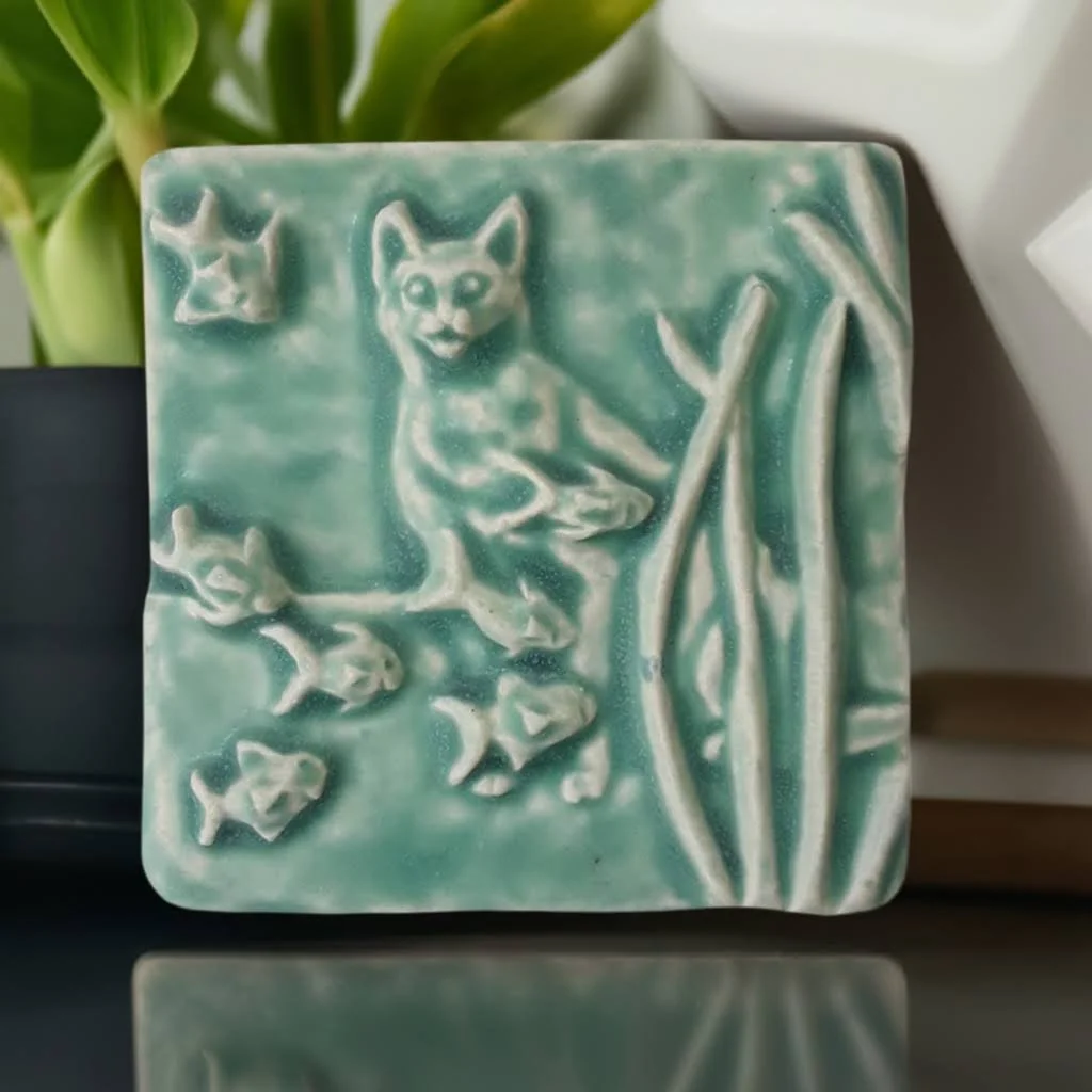 Handmade ceramic Aquarium Cat Art Tile, curious feline and fish design, unique gift for cat owners, durable porcelain for bathroom and kitchen backsplash installation.