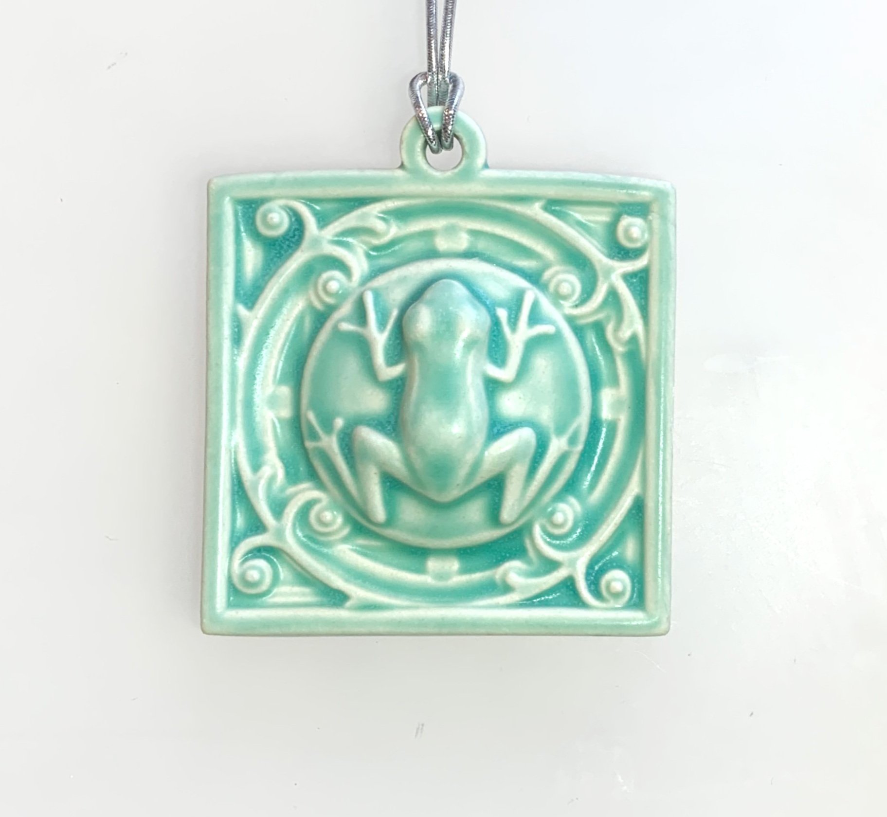 Handmade ceramic Tree Frog Art Ornament, unique porcelain gift for nature lovers, year-round decor, artisan critter ornament for holiday tree or wall.