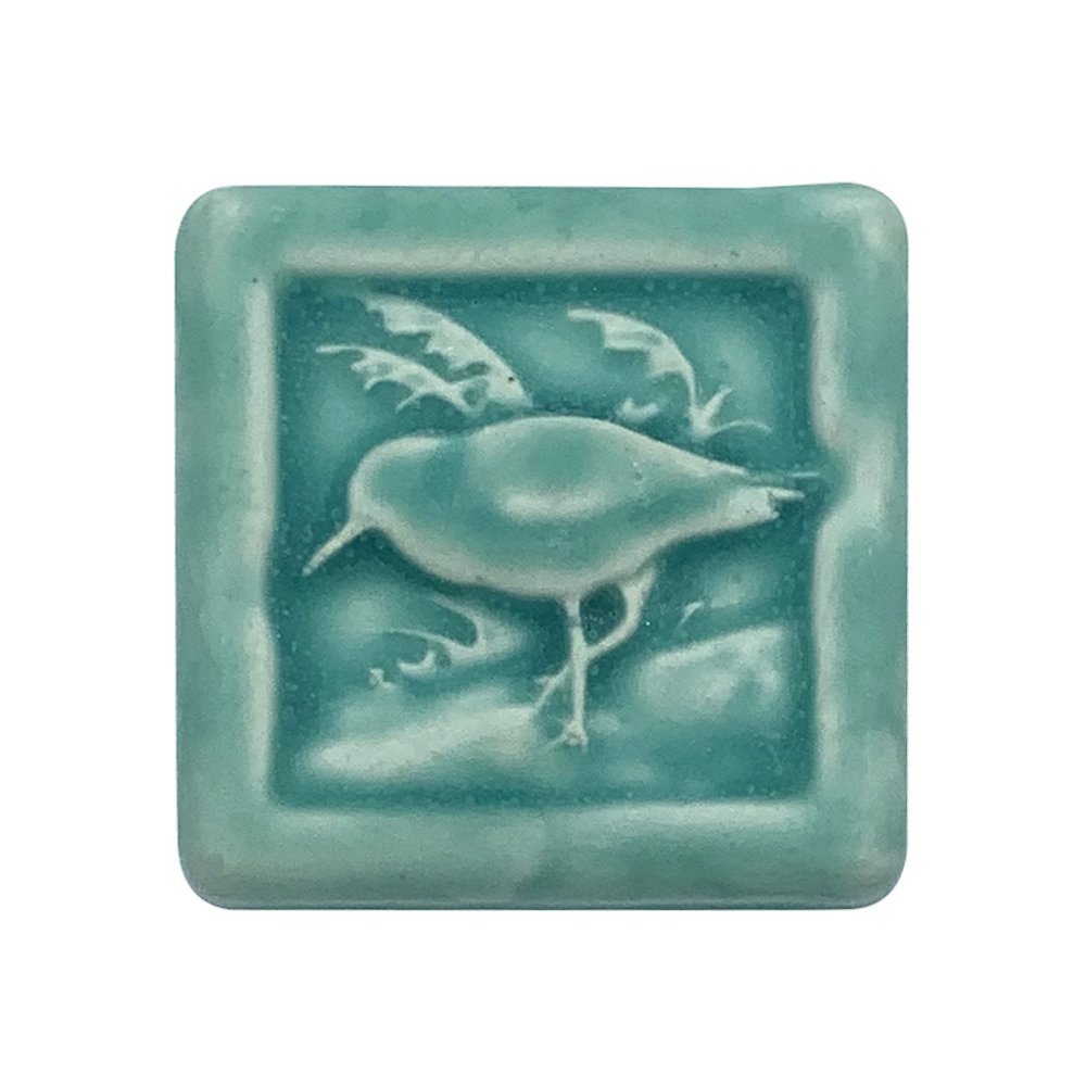 Handmade 2x2 porcelain Sandpiper art tile by Rick Pruckler and Tonya Lutz. Michigan artisan ceramic for DIY backsplashes and coastal wall decor. Moisture-resistant beach-themed gift.