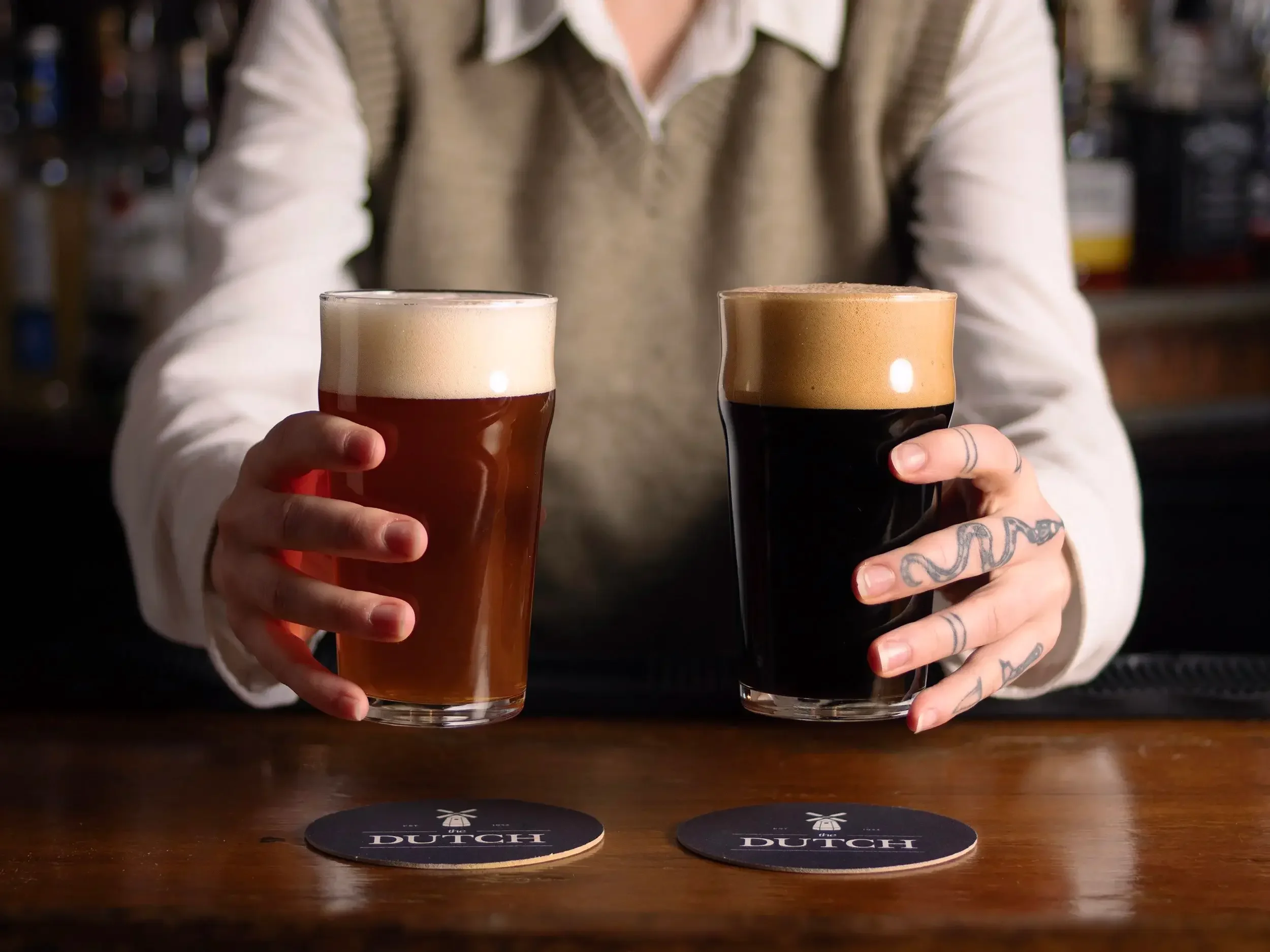  A bartender serves up two beers: a red ale and a dark stout, at the bar at the Dutch Ale House in Saugerties, NY. 