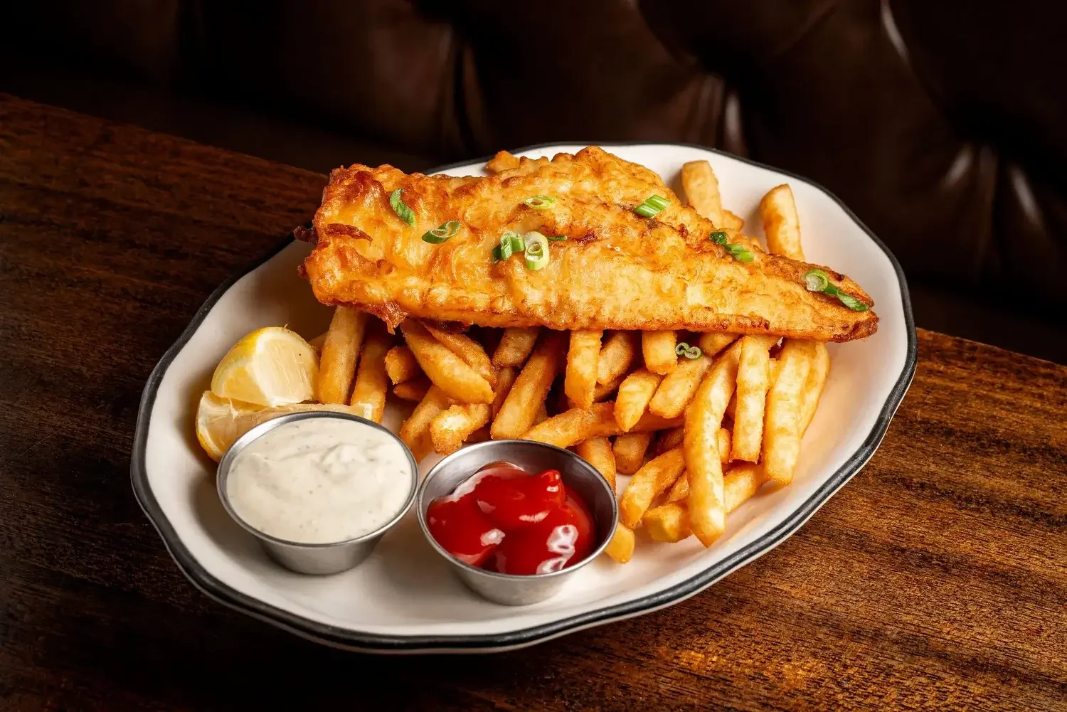 Fried fish and chips with ketchup, tarter sauce, and lemon wedges, made fresh at the Dutch Ale House in the Hudson Valley, NY.