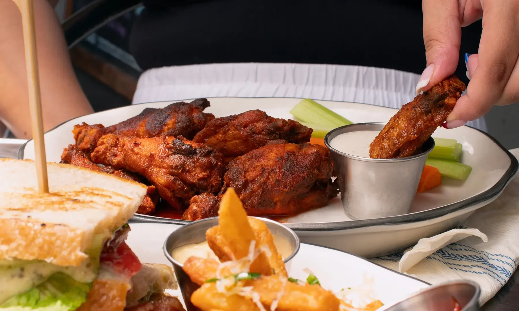 Dipping a hot wing into bleu cheese dressing at the Dutch Ale House in Saugerties, NY