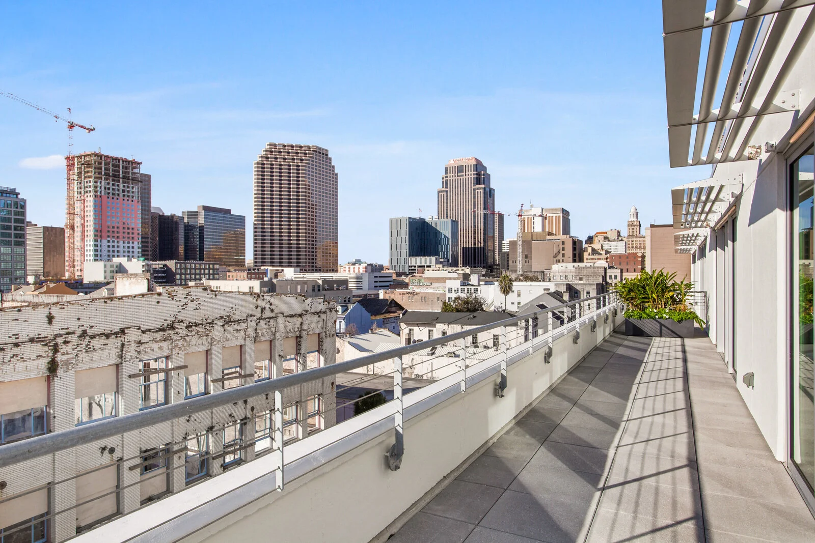  Warehouse District, LA Apartments for Rent - The Garage - Rooftop with City View, Metal Railing, and Tile Flooring 