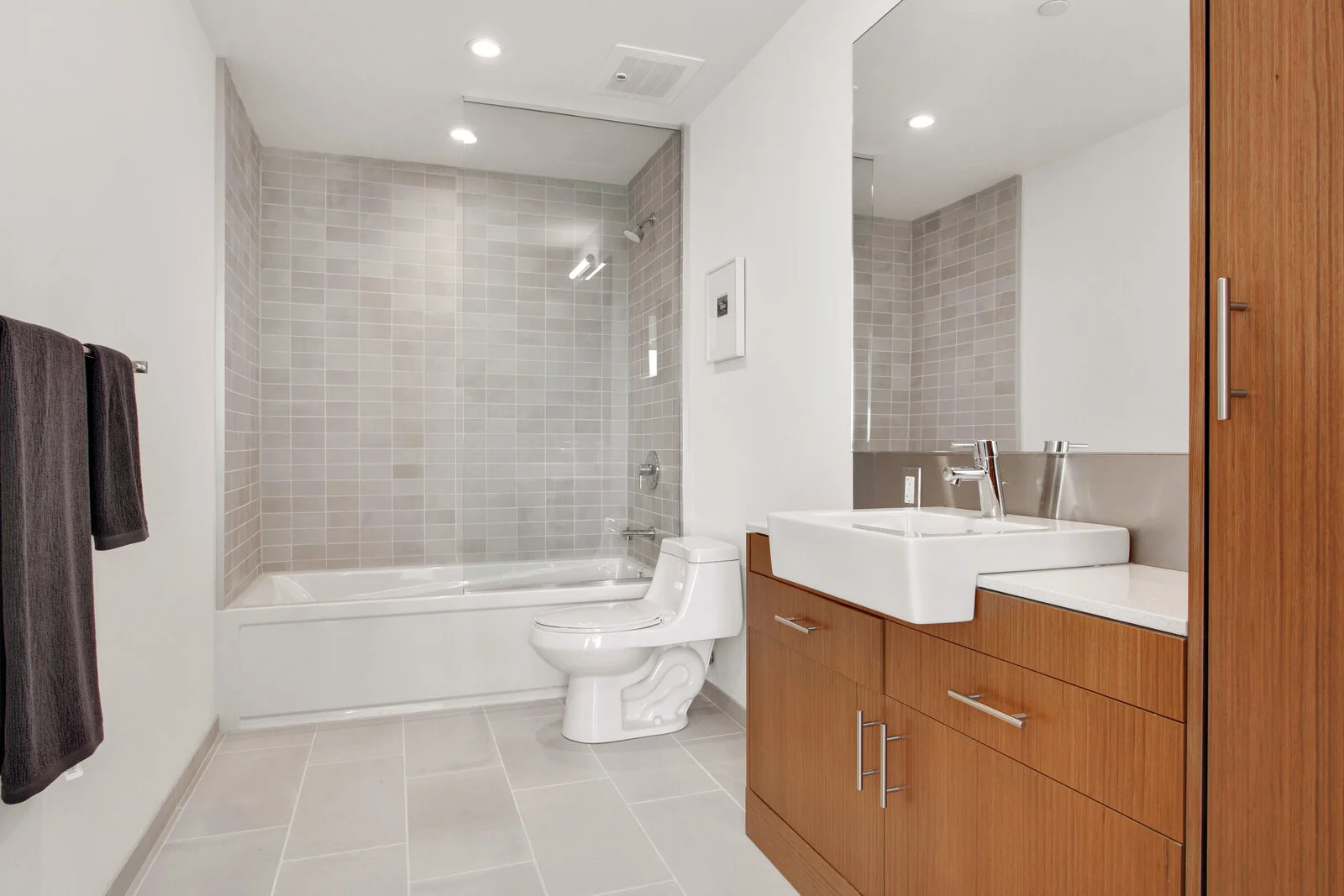  Luxury New Orleans, LA Apartments - The Garage - Spacious Bathroom with Modern Finishes, Wood Style- Cabinets and Shower Tub Combo 