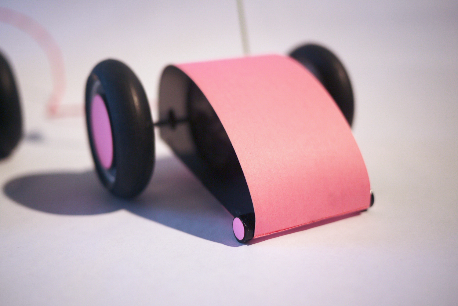  The race cars’ horsepower comes from two Tamiya 5v DC motors and gear boxes. The body and chassis are assembled out of laser cut acrylic and paper. 