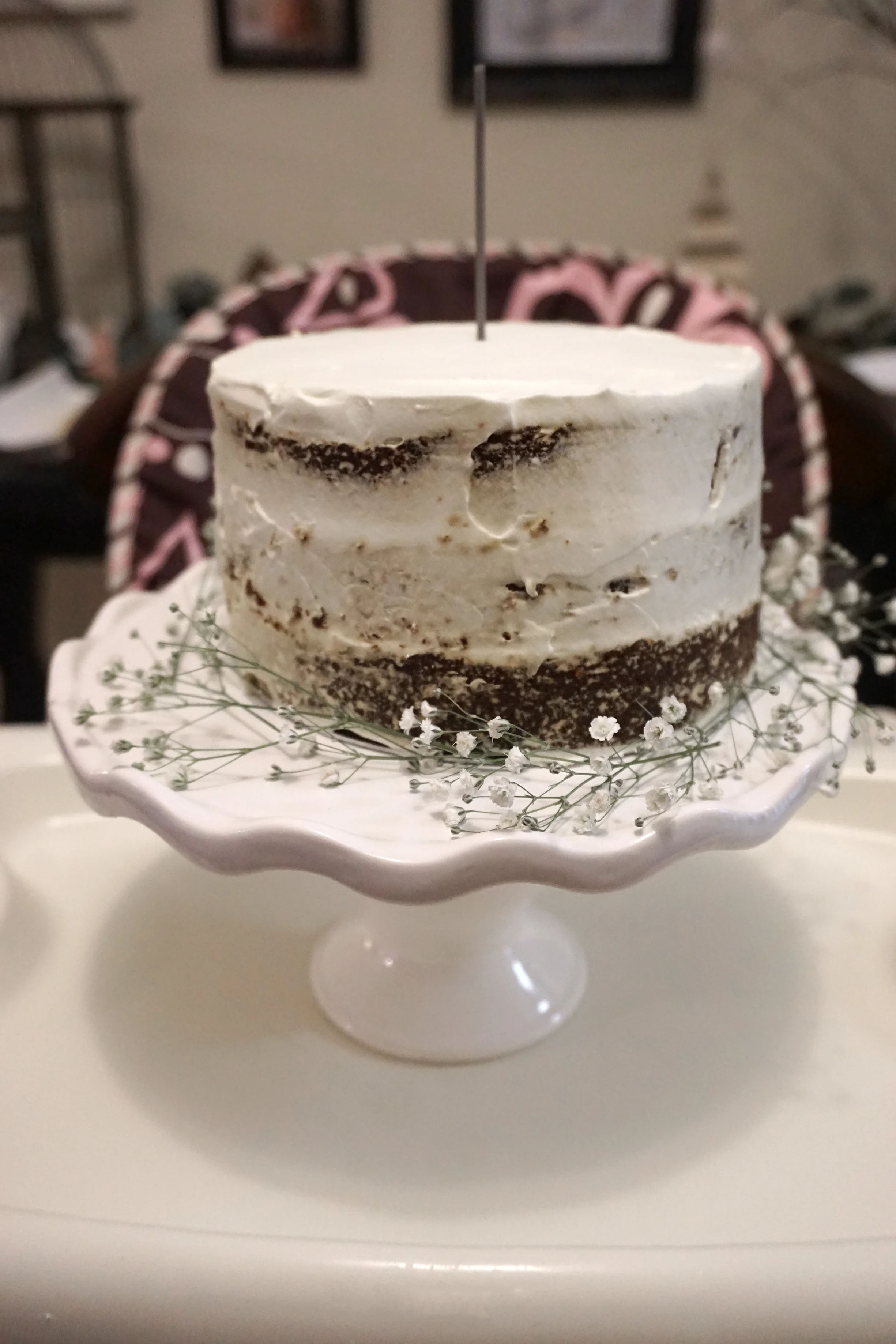 The cake almost slid off the stand when moving it onto the high chair (which is why the baby's breath is half off the stand) so what you're not seeing is a huge finger hole where I saved it ha!