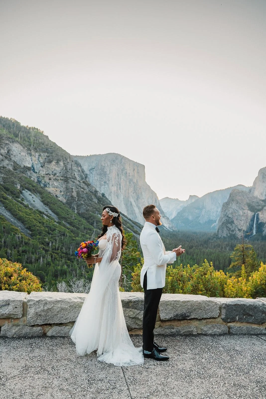 A couple share first look at the top of Glacier Point at sunrise wedding