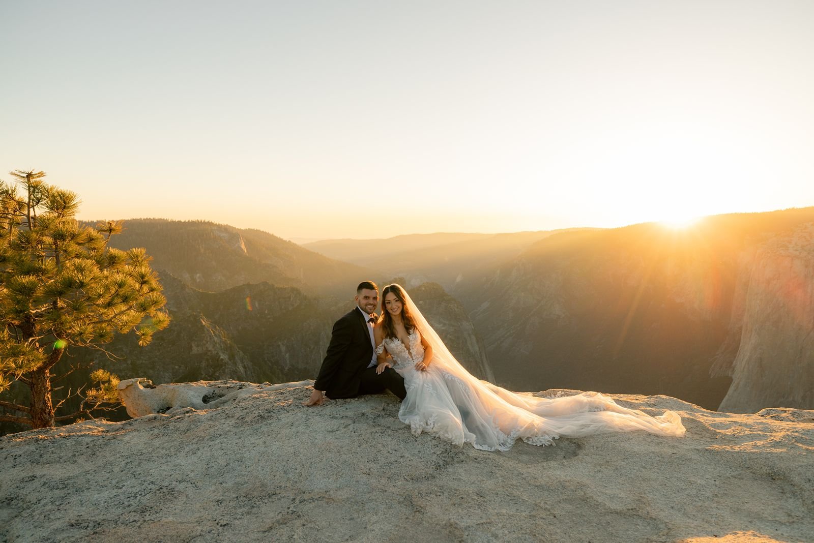 Silhouetted couple at Taft Point during golden hour, surrounded by the breathtaking cliffs of Yosemite National Park.