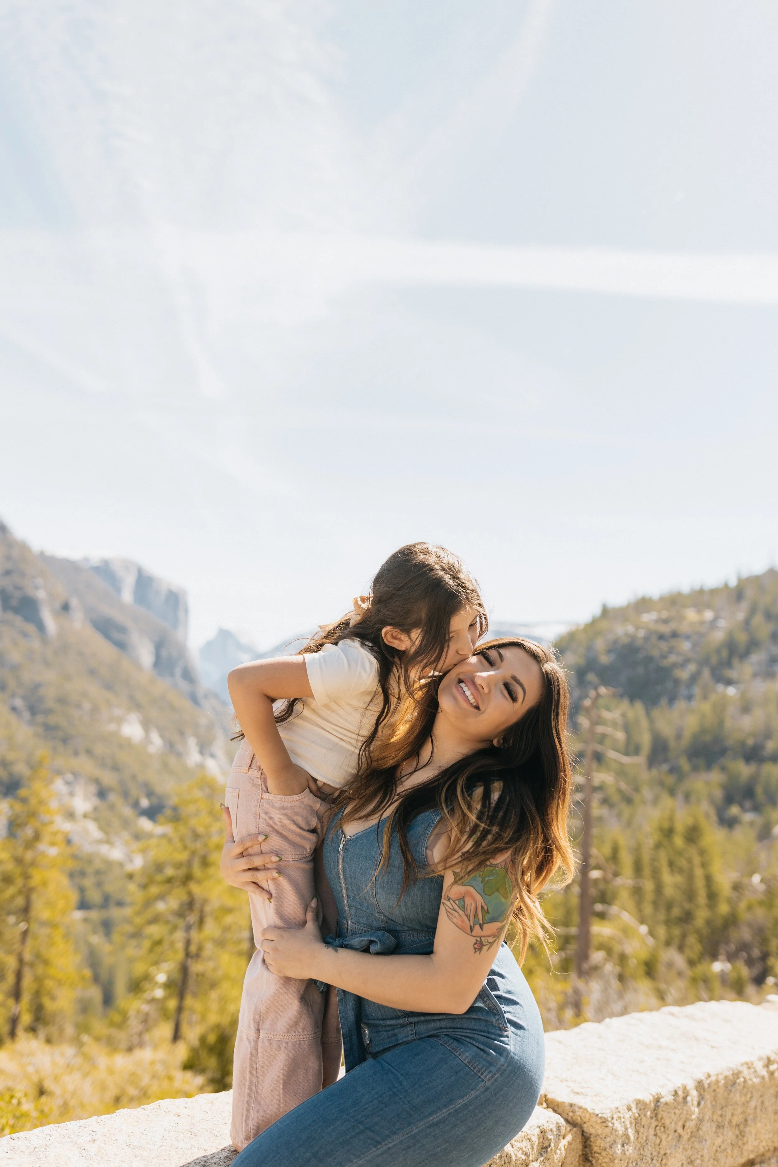 California photographer smiling candidly with her daughter at Tunnel View in Yosemite National Park.