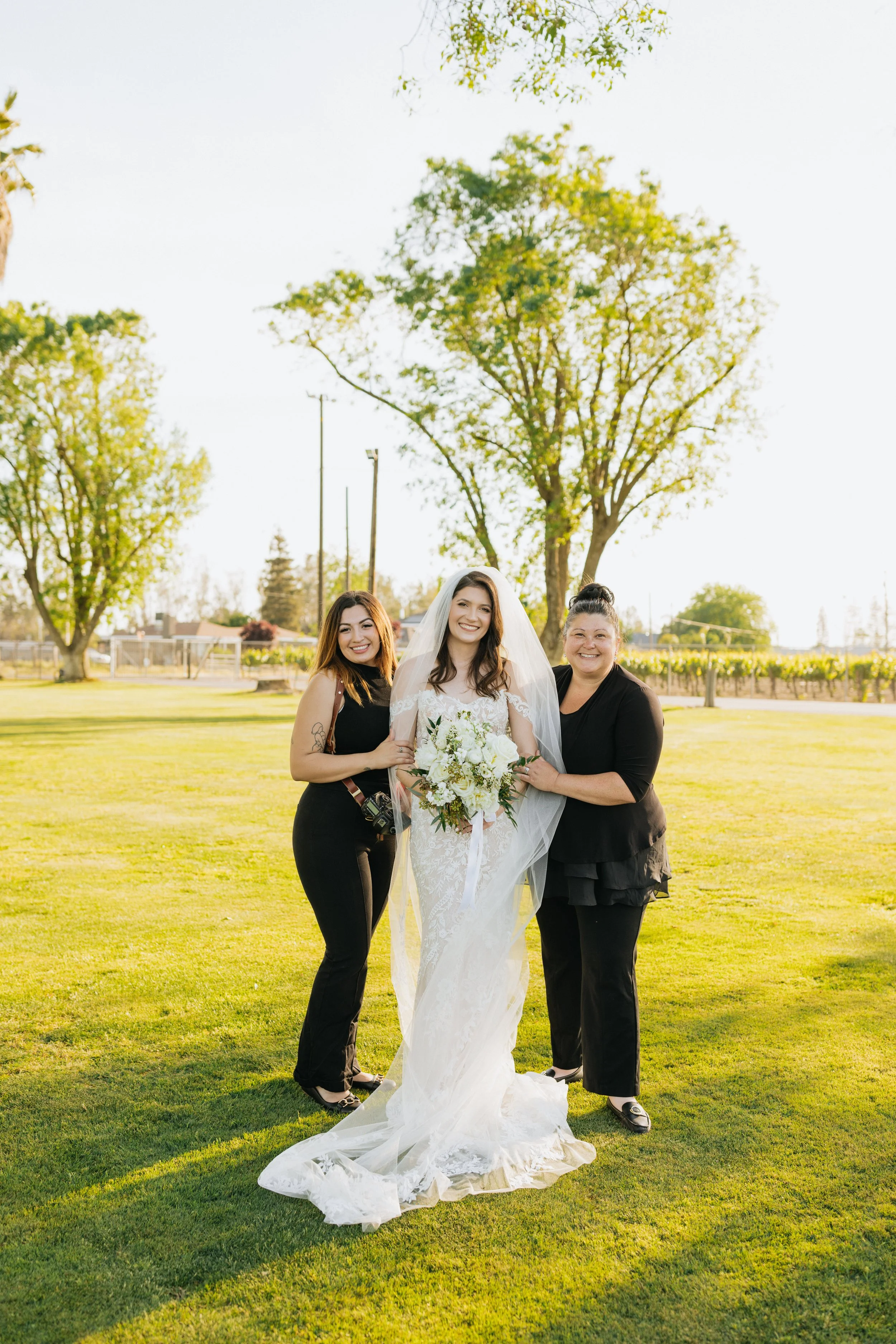 Wedding photographer Priscilla Banuelos and event planner posing happily with newlywed client.
