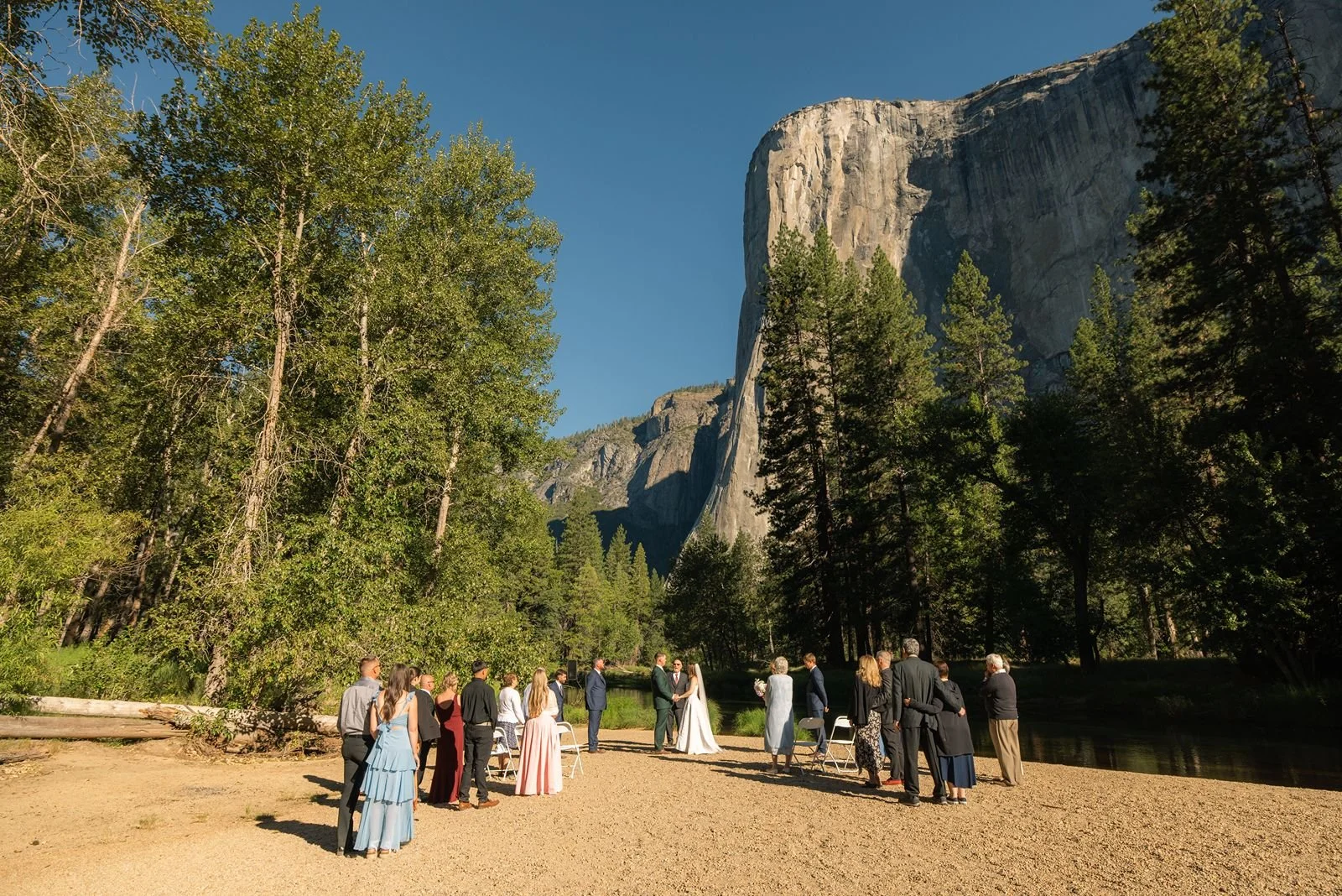 Intimate wedding ceremony at Cathedral Beach, Yosemite, with family and 20 guests surrounded by stunning natural scenery.