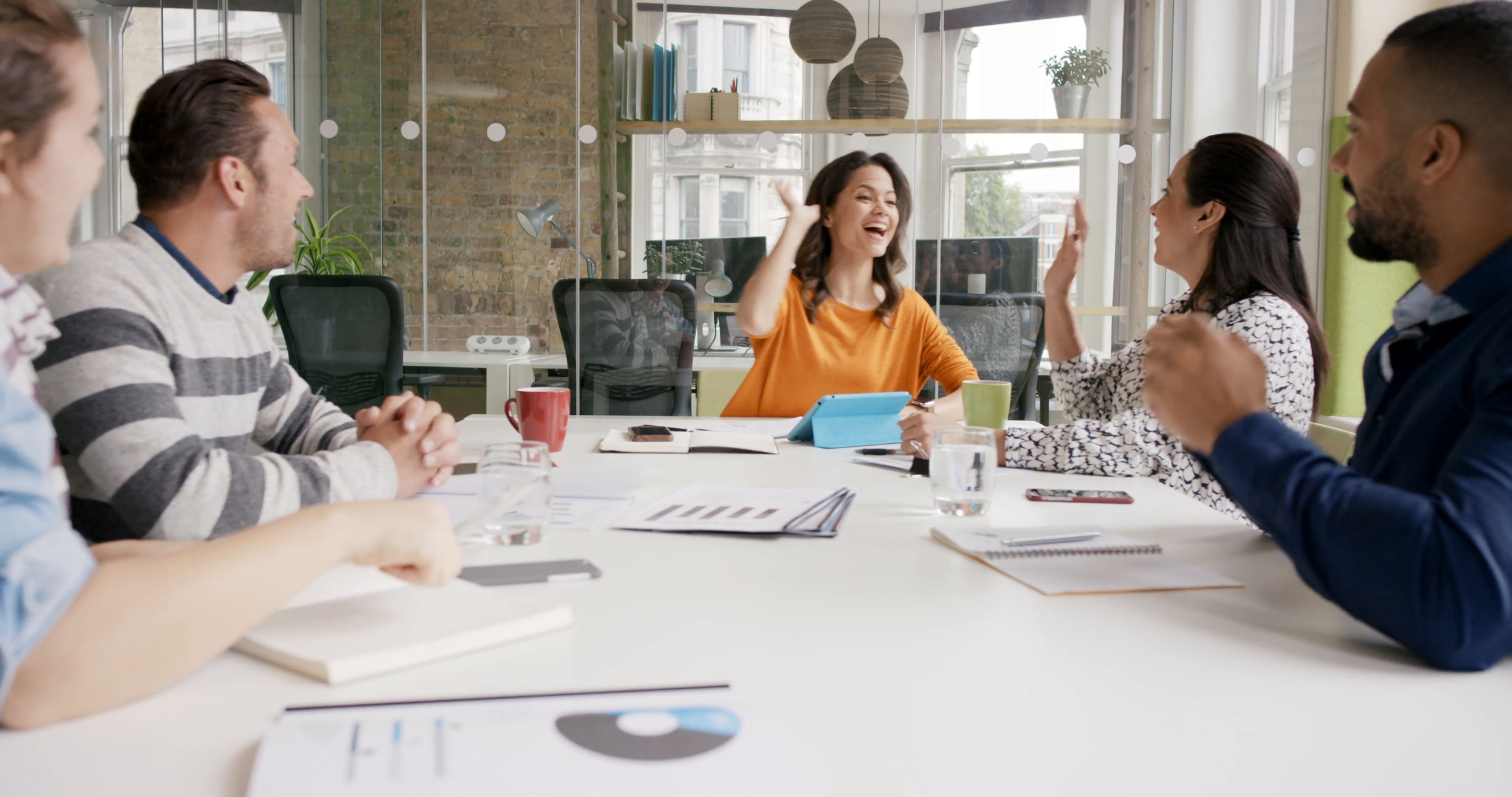 diverse-business-people-clapping-in-creative-team-meeting-celebrating-success-in-casual-modern-office-boardroom-with-natural-light-and-large-open-windows_4umvyngne__F0000.png