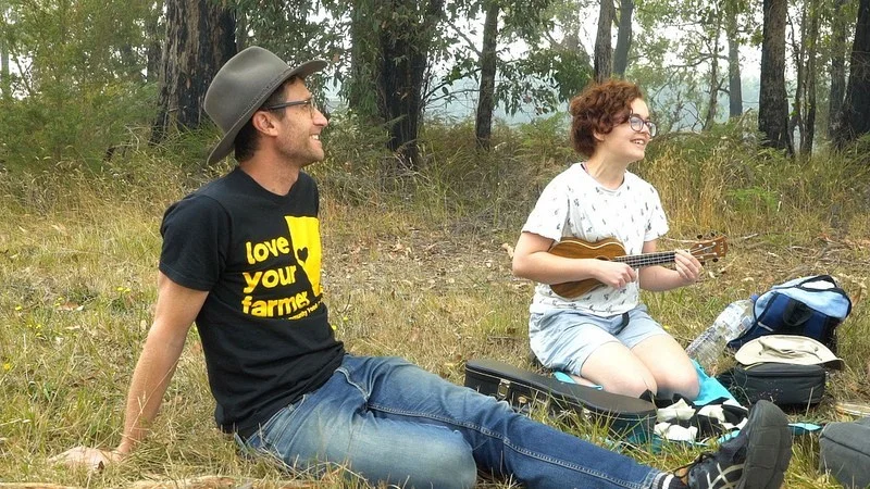 Roo Bramley (right) gives a rousing rendition of “Three Acres and a Cow” at the Hallora Recreation Reserve.