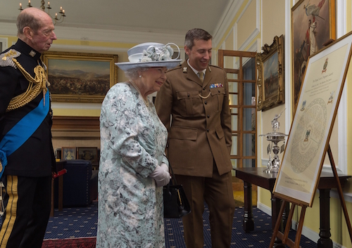 What an honour: Her Majesty the Queen admires a Roll of Honour