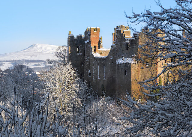 The battlements of Ludlow castle, with the distinctive summit of Titterstone Clee in the background Copyright: Shropshire &amp; Beyond