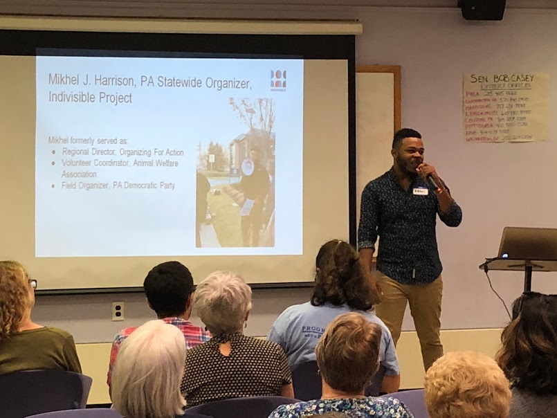  Mikhel Harrison from Indivisible PA speaking to a packed audience at the September 16, 2018 H-CAN monthly meeting. 