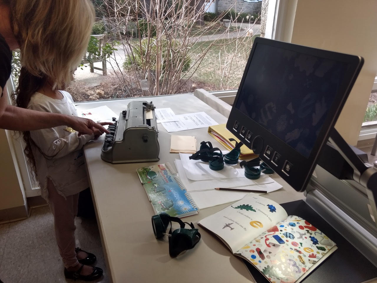  A child learning how to use adaptive accessibility technology at the How to Talk to Kids About Disability event. 