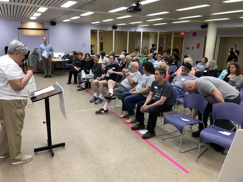Audience members wait to hear Kevin Scoglund of Citizens for Better Elections speak at the event.