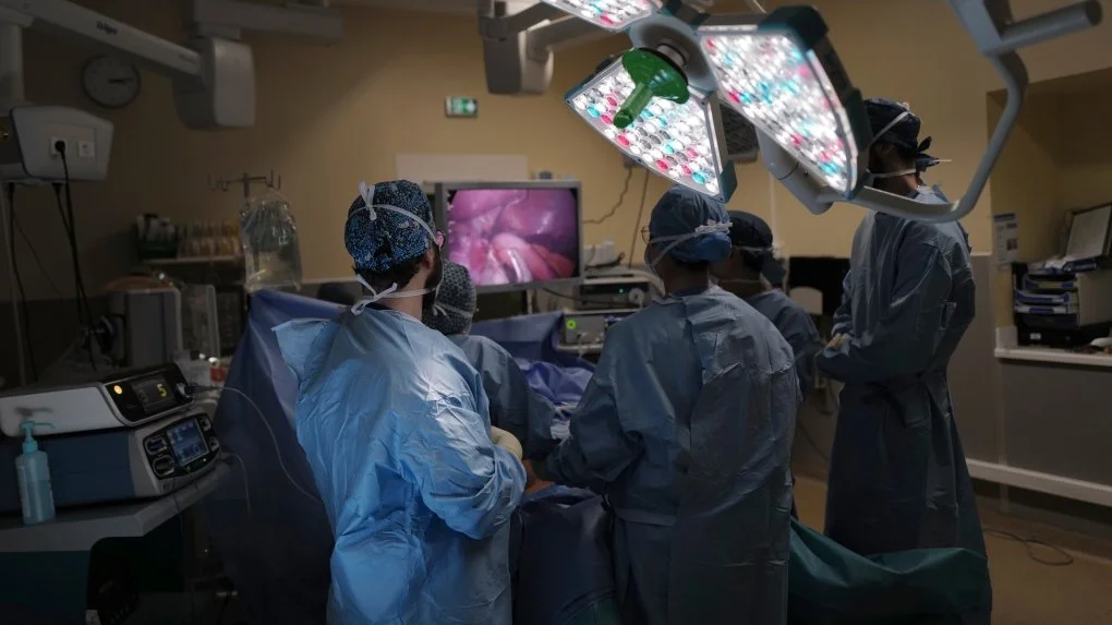 Photo shows a medical team during a surgery.