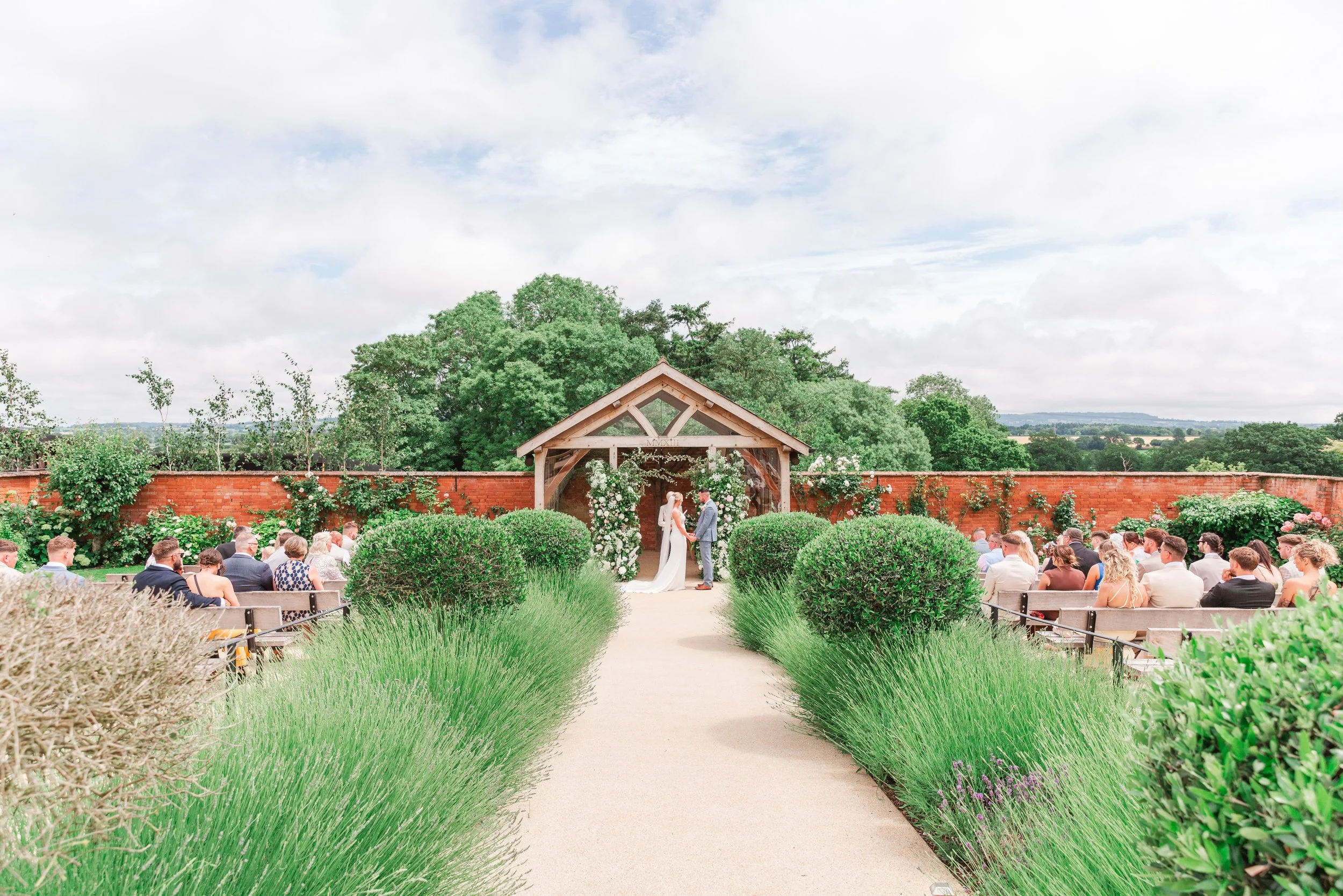 A bride and groom getting married at an outdoor ceremony in Devon