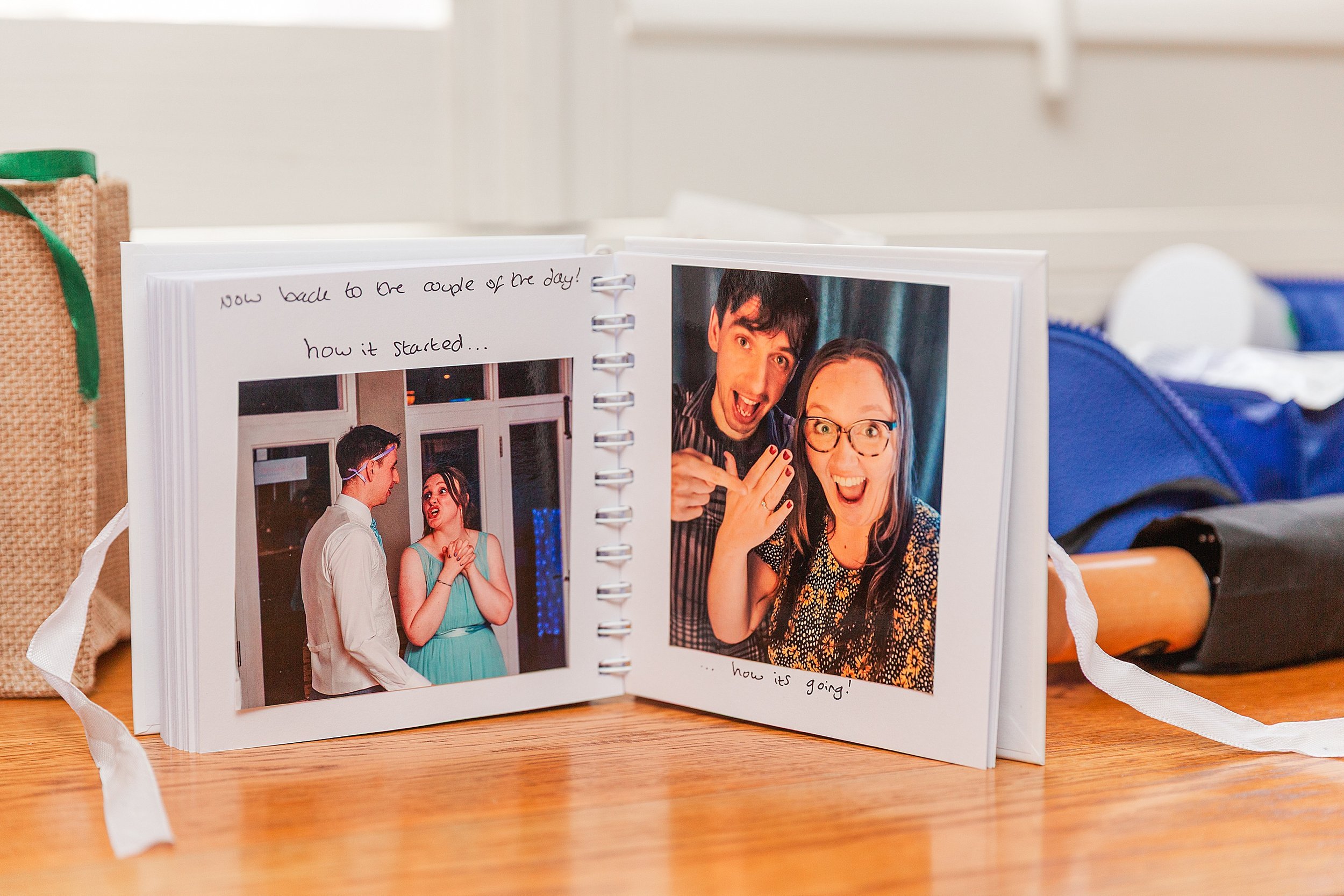 A photo book of a couple smiling at the camera showing of their engagement ring