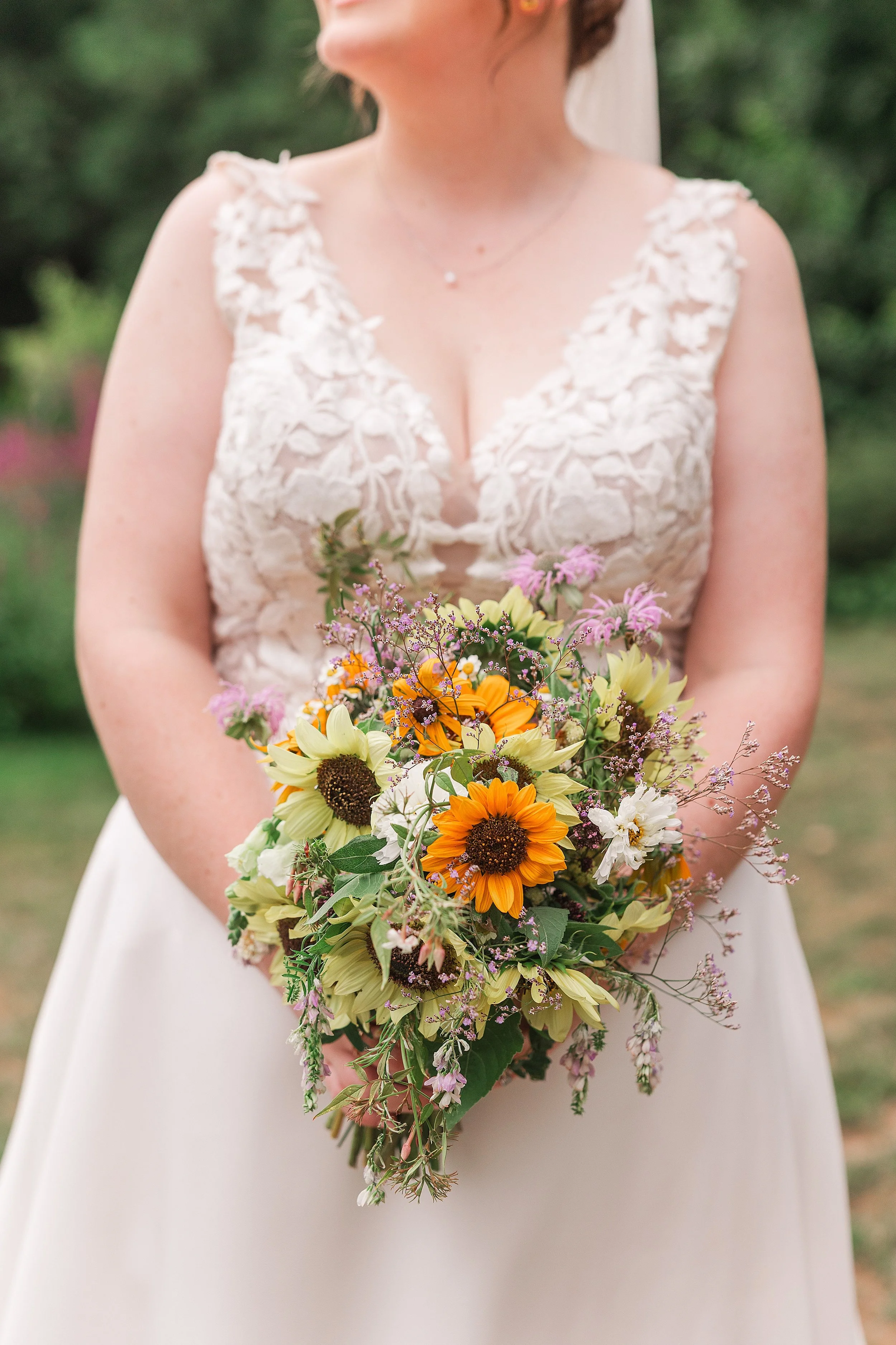 A close up of a wedding bouquet full of sunflowers