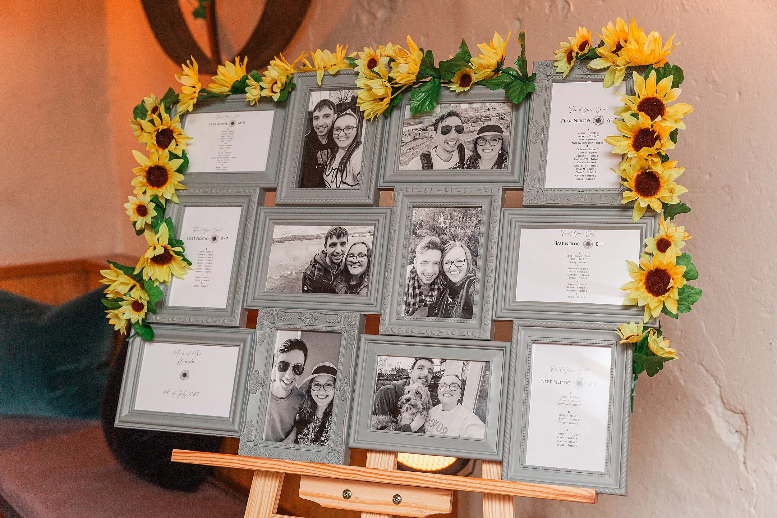 A wedding table plan with photos of the bride and groom framed with sunflowers