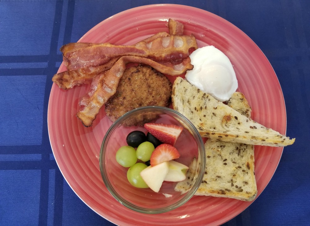 What I Had-1 HenBreakfast - 1 soft poached egg, bacon, in-house potato patty, sourdough bread & fresh fruit