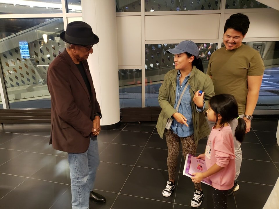 Girl shows Floyd Norman her drawing