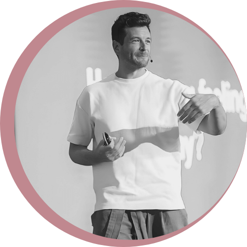 Image of Roy Gluckman speaking at an event with a smile on his face and hands gesticulating