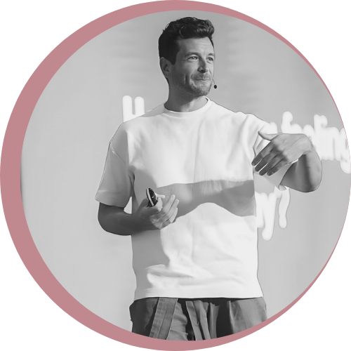 Image of Roy Gluckman speaking at an event with a smile on his face and hands gesticulating