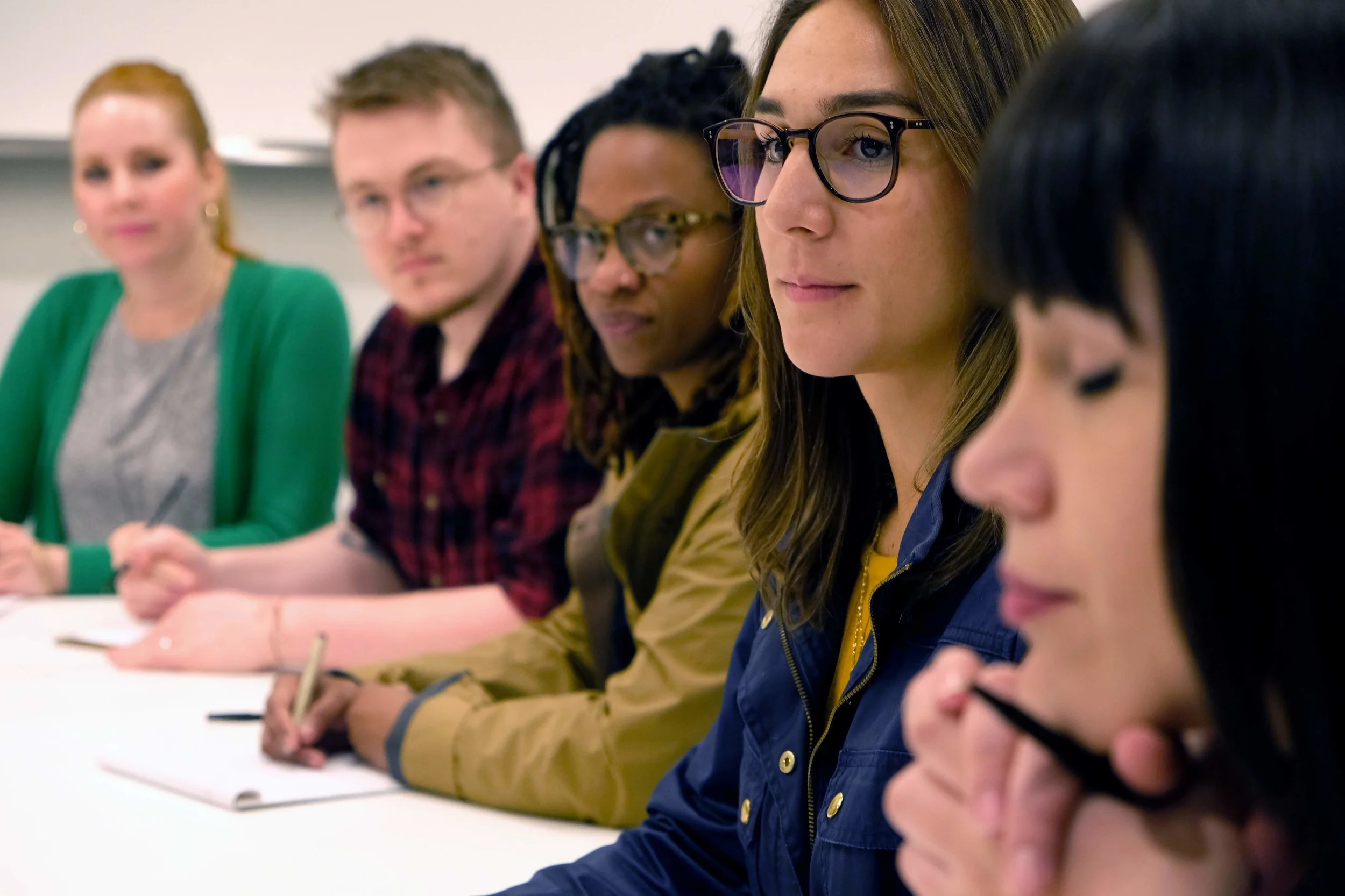 Mock jury participants listen during the deliberation part of the research session.