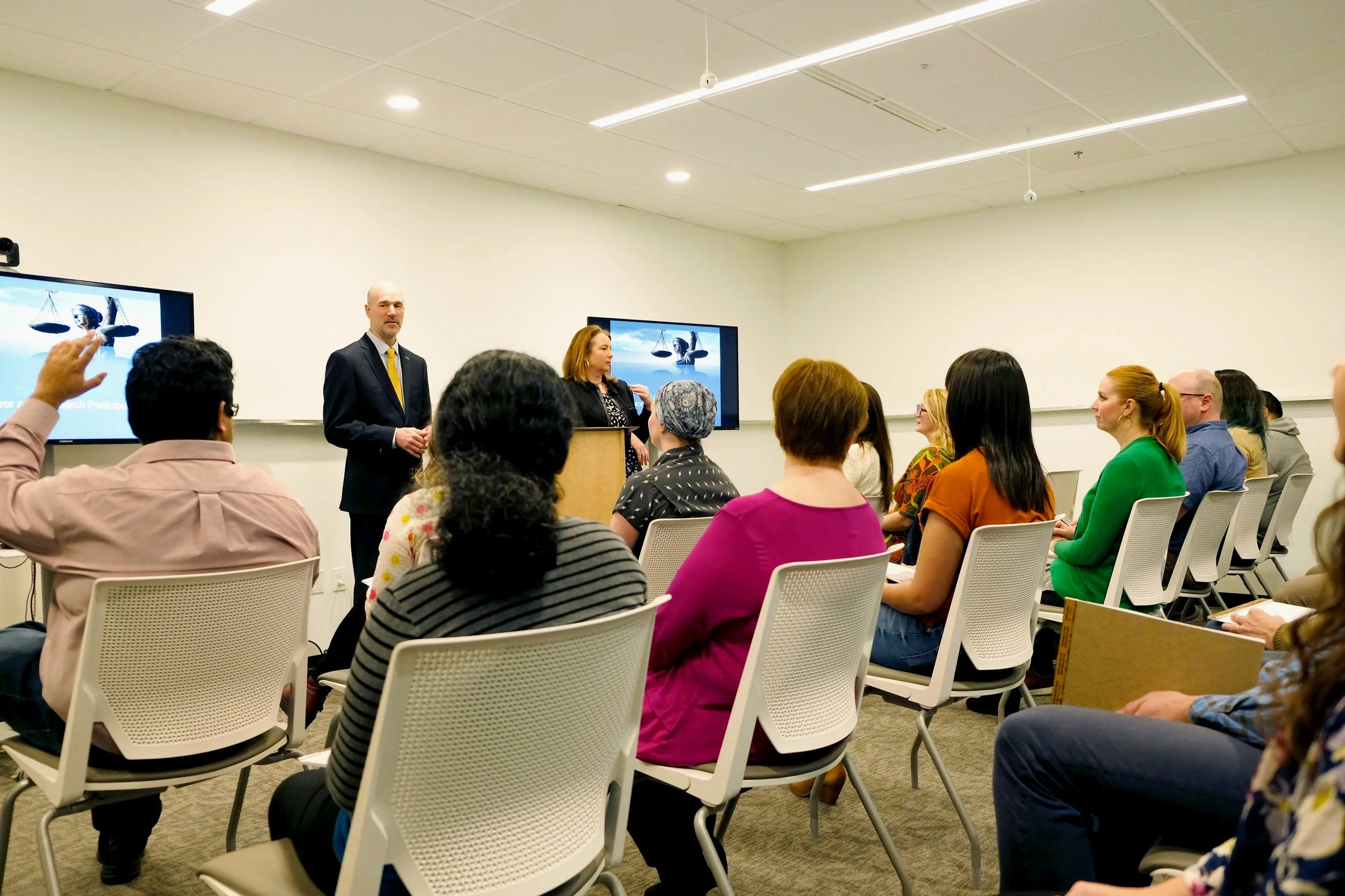 Mock jury participants listen to a case presentation from Mind Matters consultants.